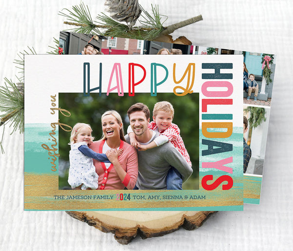 colorful holiday photo card with a single photo, multi-color text, and a watercolor teal and gold background