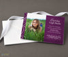 photo graduation announcement in a horizontal format with a single photo on left, purple background and white text printed on cardstock with a stack of white photos