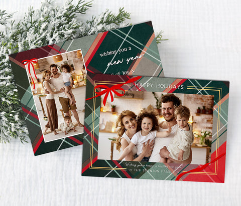 landscape oriented holiday card with a single photo, thin border, ribbon detail and multi-color plaid background