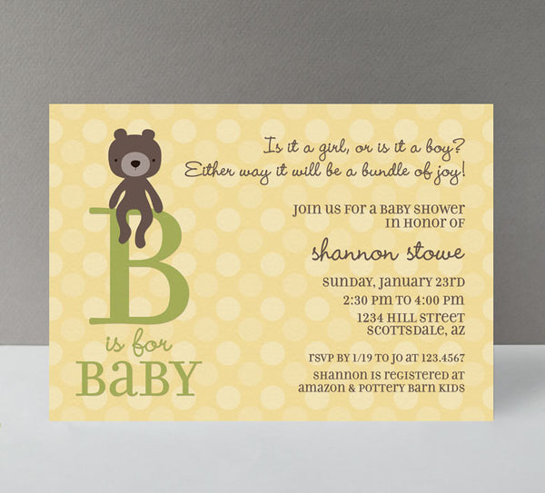 gender neutral baby shower invitation with yellow polka dot background, green B is or baby text, brown teddy bear graphic