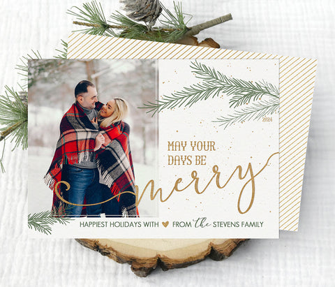 christmas photo card with white background, a single photo, gold text and green pine branches, back side is striped gold pattern