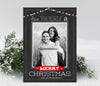 christmas photo card with black chalkboard background, single photo, and red and blue holiday light strings along top