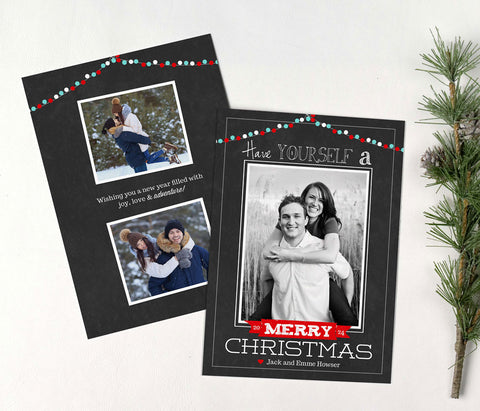 christmas photo card with black chalkboard background, single photo, and red and blue holiday light strings along top