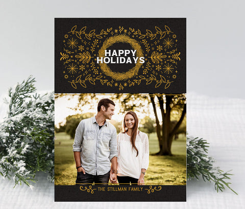 simple holiday christmas card in modern minimalist style witha single photo, black background and gold colored line drawn foliage