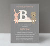 girl baby shower invitation with gray striped background, toy shelf with brown teddy bear, pink tiara, pink bunny and letter B, white text