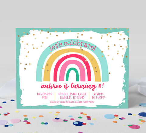 rainbow themed girls birthday invitation with teal border, rainbow graphic, fold confetti and various fonts