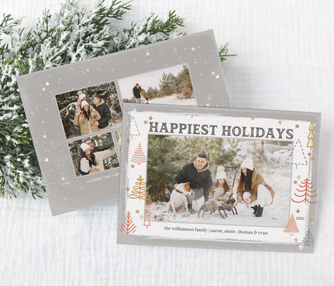 landscape oriented holiday card with a single photo framed by rose gold and gold tree shapes against a gray and white watercolor 