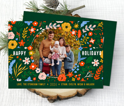 horizontal christmas or holiday card with a single circular photo framed with vintage floral graphics against a green background