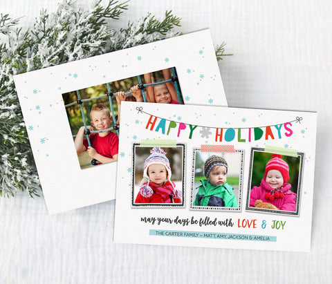 holiday christmas photo card with white background, colorful text in banner style, and hand drawn frames around three photos.